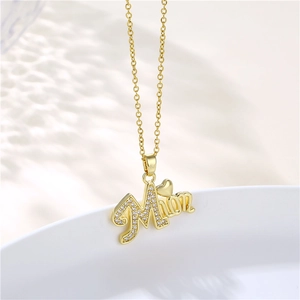 Detailed view of gold MOM pendant with cubic zirconia heart on stainless steel chain