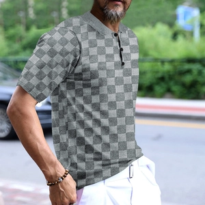 Detail of grey checkered jacquard pattern and collar buttons on men's short sleeve polo