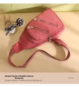 Detail view of pink nylon chest bag featuring multiple zipper pockets and adjustable strap