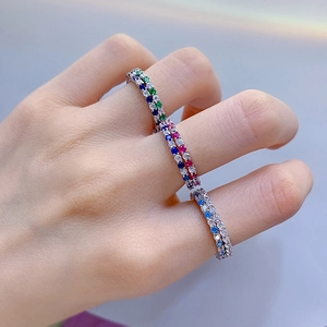 Close-up of slim S925 silver rings set with colorful zircons worn on hand