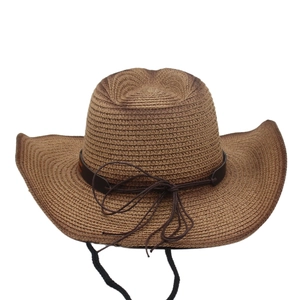 Detail of tan woven straw cowboy hat with dark leather band and adjustable chin strap