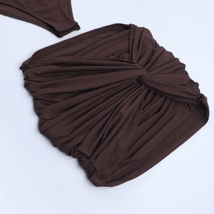 Detailed view of the brown knitted texture and center knot design on the slim-fit skirt