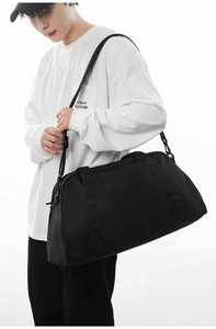 Detail shot of a large black waterproof travel duffel bag for sports, gym and business trips