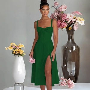 Detail showing the pleated bust design and high side slit on the green midi dress
