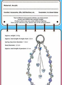 Close-up macro view of beaded phone strap details with crystal heart and butterfly charms