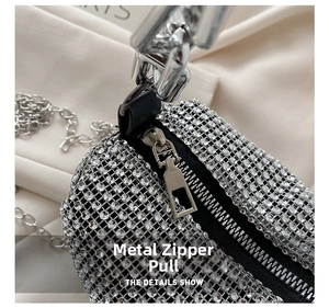 Detail of silver rhinestone evening bag featuring a premium metal zipper and sparkling crystals