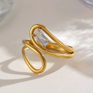 Detail view of a gold-plated irregular ring featuring a rectangular zircon stone