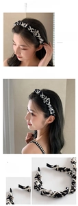 Detailed view of paisley print pleated headband with elegant white pearl embellishments