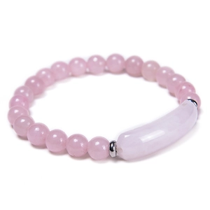Detail view of pink rose quartz beaded bracelet with a cylindrical stone and silver spacers