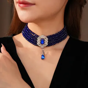 Vintage 5-row blue bead choker with ornate silver pendant and teardrop gemstone charm