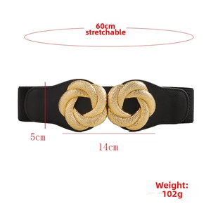 Detail of black elastic belt featuring golden interlaced knot buckle and leather ends
