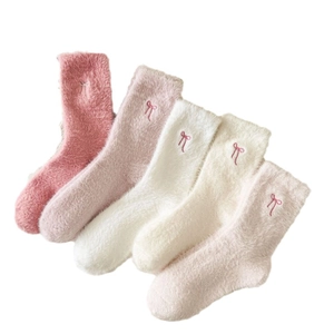 Five pairs of plush winter socks in pink and beige with cute embroidered bow details