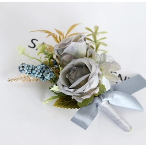 Close-up of vintage grey rose boutonniere with blue berries and silk ribbon bow
