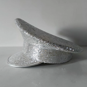 Detail of silver sequined captain hat showing intricate sewing and metallic glitter texture