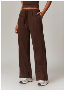 Detail of high waist drawstring and vertical seam on dark brown wide leg sweatpants