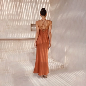 Detail of the caramel satin dress featuring a backless design with crisscross tie-up straps