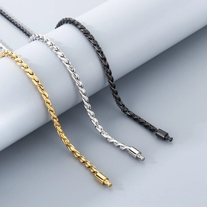 Detailed view of twisted curb chain necklaces in gold, silver, and black finish