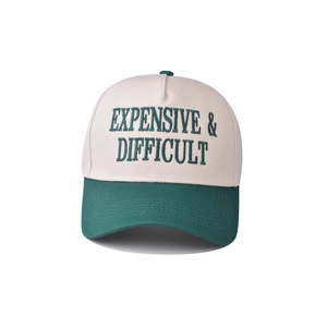 Close-up of the green letter embroidery on this two-tone cotton baseball cap