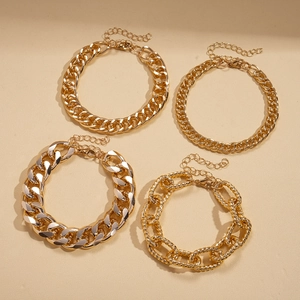 Detail showing 4-piece gold chain bracelet set including curb and twisted cable textures