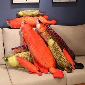 Realistic cartoon golden dragon fish plush pillow collection in various sizes on sofa