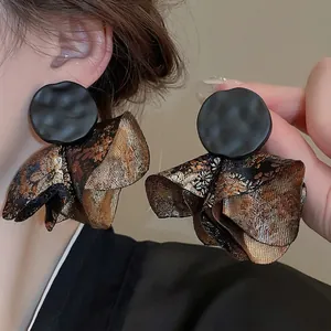 Modern oriental petal earrings with black pleated metal and gold floral lace embroidery