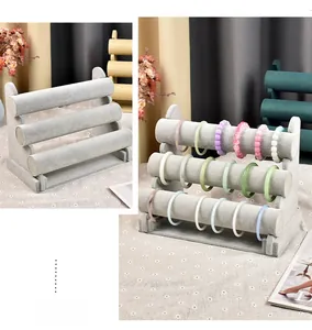 Three-tier gray velvet jewelry stand for bracelets and watches with cylindrical tiered design