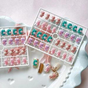 3D cartoon resin nail charms set with cute animals like cat rabbit and bear on blue plate