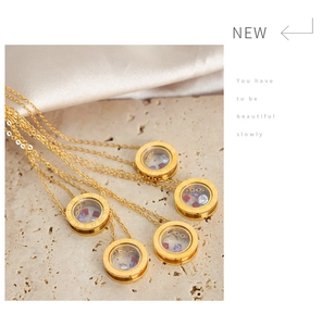 Detail of round gold necklaces with Roman numerals and colorful crushed stones