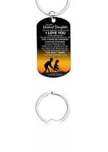 Close-up of engraved stainless steel keychains with sentimental messages for daughter