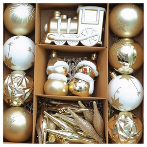 Detail view of a 70-piece set of gold and white Christmas ornaments in a grid display