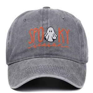Detail of orange Spooky Season embroidery with ghost on washed grey baseball cap