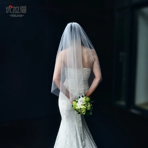 Elegant long cathedral bridal veil with a white lace mermaid wedding gown back view
