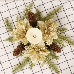 Christmas candle ring wreath with golden flowers, pine cones and artificial pine needles