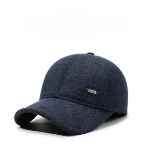 Close-up of thick navy blue textured fabric with a SPORT metal badge on winter baseball cap