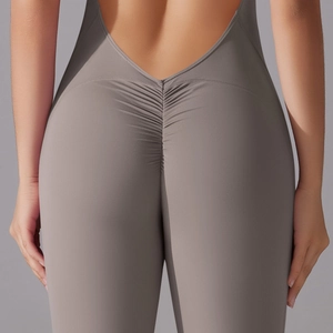 Detailed back view of grey yoga bodysuit featuring a deep V open back and scrunch butt design