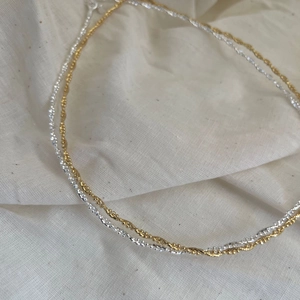 Minimalist 925 sterling silver beaded necklace in gold and silver finish on linen
