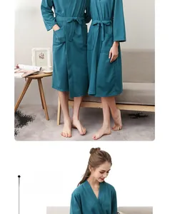 Detail of teal waffle knit bathrobe showing textured fabric and belted waist for couples