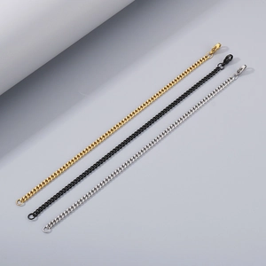 Detailed comparison of Cuban link chains in gold, black, and silver stainless steel finishes