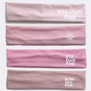 Detailed close-up of four shades of pink elastic cotton sports headbands for running