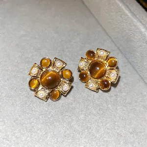 Vintage floral cat eye stone earrings with golden metal petals and white pearls