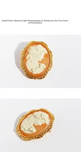 Detailed macro view of vintage golden cameo brooch with orange relief and filigree edge