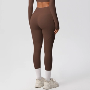 Close-up of high-waist coffee yoga leggings with peach lift seams and matte finish