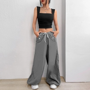 Women casual outfit featuring black crop tank top and grey cargo wide leg pants