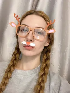 Close-up of reindeer Christmas party glasses with hanging beard accessory on a model