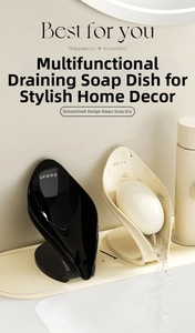 Close-up of UFORU self-draining leaf-shaped soap dishes in black and cream finishes