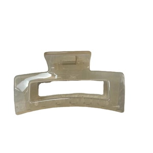 Minimalist rectangular jelly hair claw clip in transparent beige resin on white background