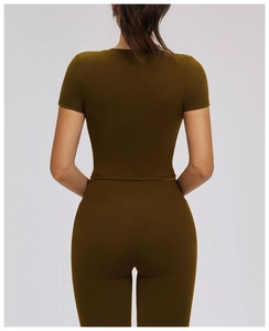 Rear view of tight olive green short sleeve crop top and high waist leggings fitness set