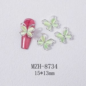 Close-up of cat eye opal butterfly nail art charm with zircon stone in silver frame