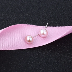 Macro view of S925 sterling silver pink freshwater pearl earrings on black background