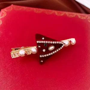 Red velvet triangle hair clip with pearls and rhinestones on luxury jewelry box